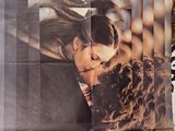 a poster of a couple kissing each other on a tree
