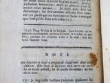 an old book that is open on a table