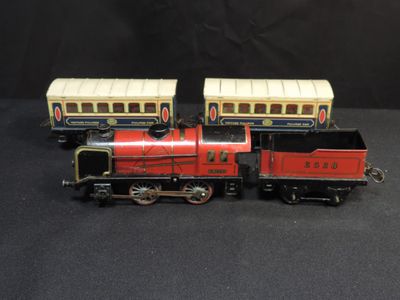two toy trains sitting side by side on a black surface