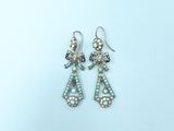 silver and mother of pearl earrings on a white background
