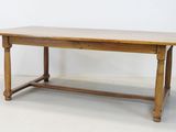 an image of a wooden table with a wooden top on a white floor