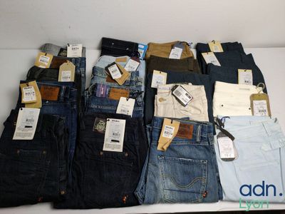 several pairs of men ' s jeans are laid out on a table