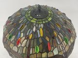 a close up of a stained glass lamp on a stand