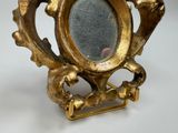 a picture of a gold frame with a mirror in it
