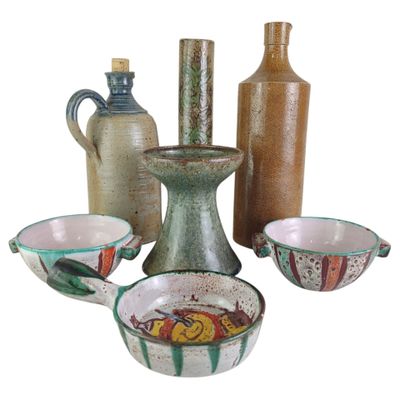 many different types of vases and bowls on the table