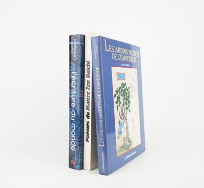 two books sitting on top of each other on a white surface
