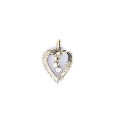 a close up of a heart shaped pendant on a white background