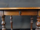 a small wooden table with a drawer on top of it
