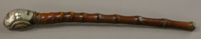 a wooden stick with a metal handle on it