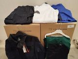 a pile of clothes sitting on top of a cardboard box