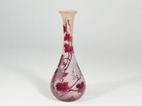 a glass vase with a red and white design on it