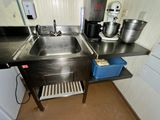 a kitchen with a sink and a mixer on the counter