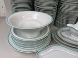 a lot of plates and bowls on the table