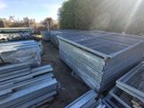 a lot of metal pallets that are stacked together