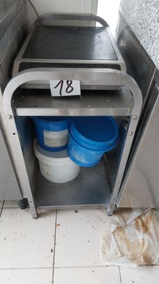 a trash can and buckets in the corner of a kitchen