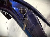 a blue motorcycle with a bunch of keys attached to it