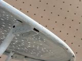 a close up of a metal chair with holes in the back
