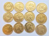 the gold coins are arranged in rows on a white surface