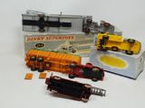 several toy trains are sitting on a white surface next to a box