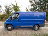 a blue van that is parked in the grass