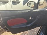 a picture of a car door with a red seat cover