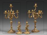 three different views of a gold colored candelab with three candles