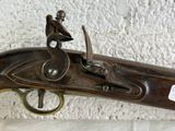 a gun with a man sitting on top of it