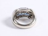 an image of a ring with blue stones on a white surface