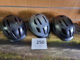 trois casques posés sur une table, à côté d'un panneau