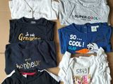 many t - shirts laid out on a cardboard box
