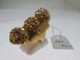 an image of a gold plated broochle with a tag on it