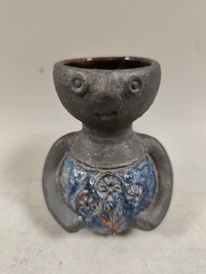 a small gray vase with a blue design on it
