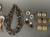 a lot of jewelry that is laying out on the table