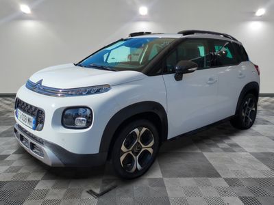 the white citrole is parked in a large room with a checkered floor