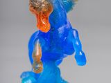 a blue and orange horse statue on a white surface