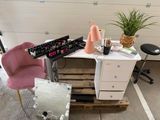 a desk with a mirror, a chair, and a mirror on it
