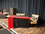 many chairs and tables set up on the stage