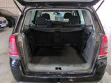 the back of a car with its trunk open in a garage