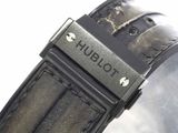 a close up of a watch with a leather band