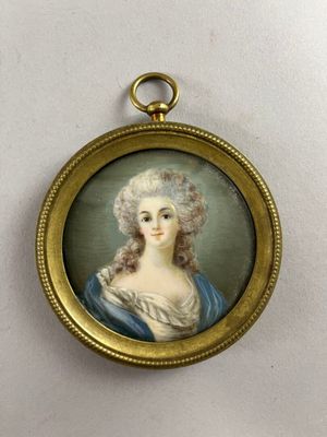 an antique miniature portrait of a woman in a blue dress