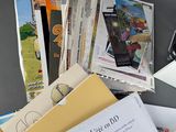 a pile of papers and a cell phone on a table