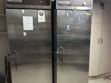 two stainless steel refrigerators in a kitchen next to each other