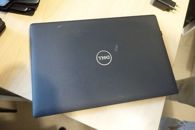 dell laptop on a table in a home office setting