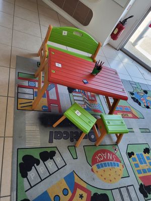 brightly colored children ' s table and chairs in a brightly colored area rug