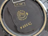 a close up of a black plate with a gold trim