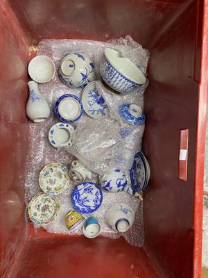 a red container filled with lots of blue and white dishes