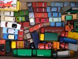 a box full of toy cars and trucks that are in it