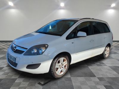 a picture of a blue and white minivan in a room