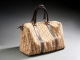 an image of a brown and black handbag on a gray surface