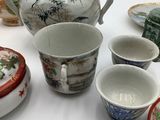 many different types of asian pottery on the table